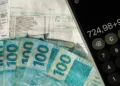 Notas de dinheiro, conta e calculadora representam pagamento da restituição do Imposto de Renda.