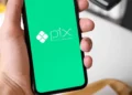 Celular com o Pix na tela, representando as mudanças do Banco Central nas regras do Pix Automático para cobranças recorrentes.